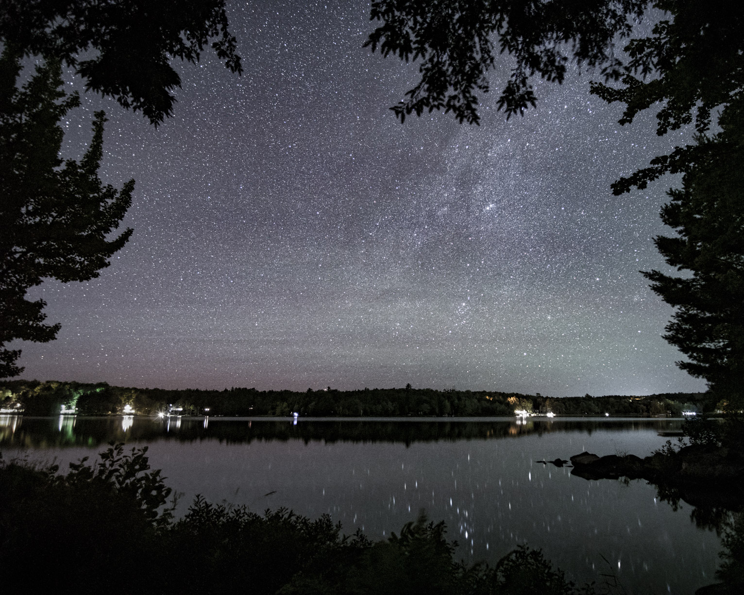 From a window in the trees the lake and stars above